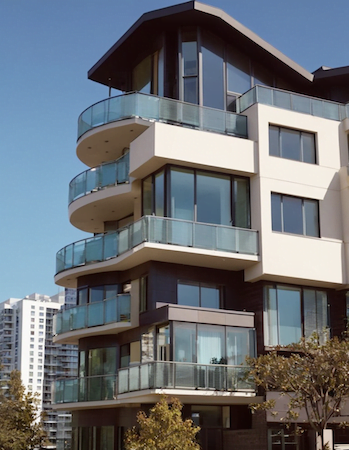 A renovated modern apartment building with balconies, showcasing its contemporary design and outdoor spaces.